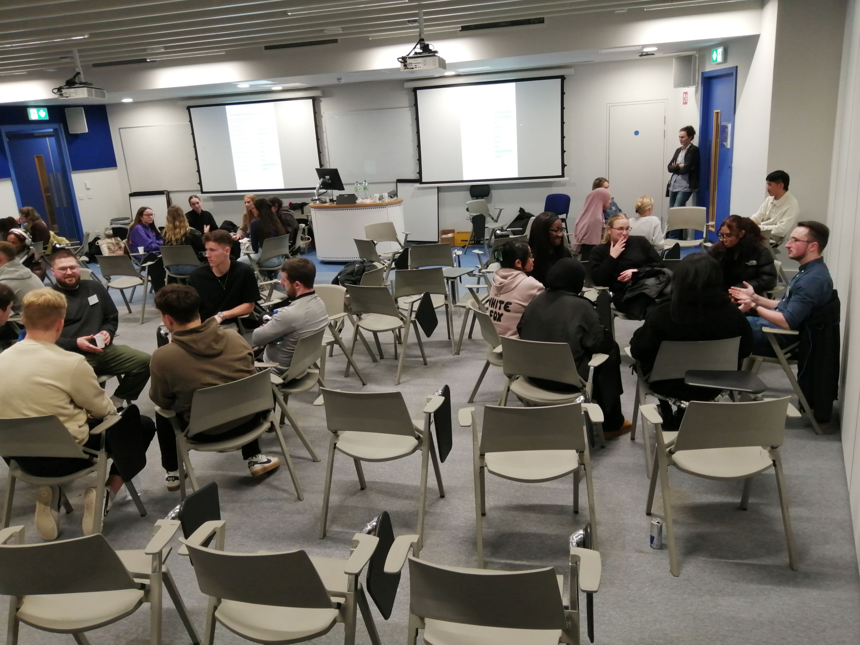 Students sitting around tables for careers evening.