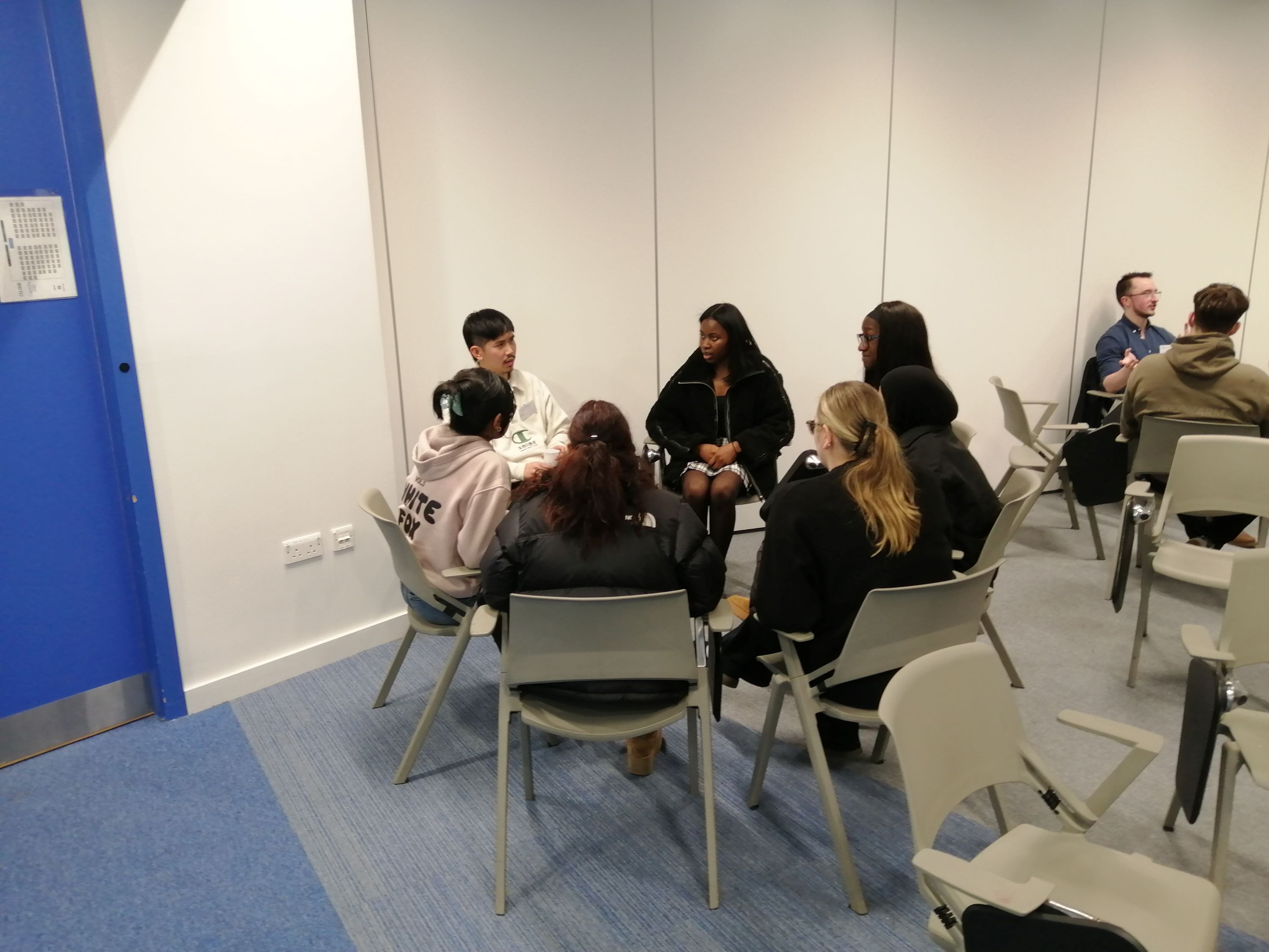 Students sitting around tables for careers evening.