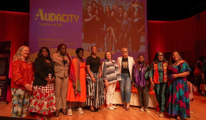 A group of people on a stage at an event