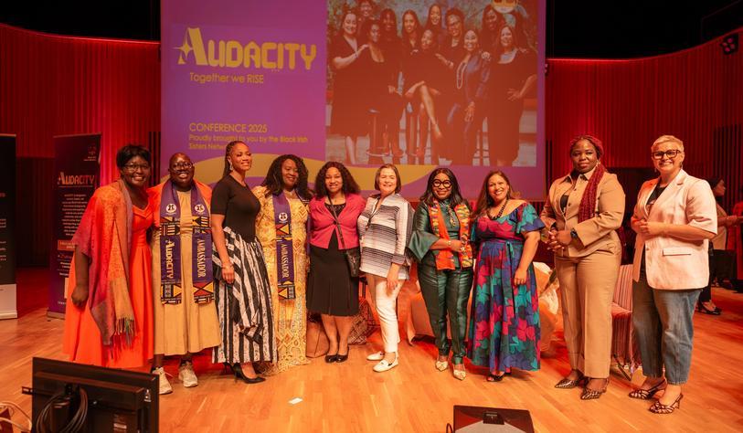 A group of people on a stage at an event