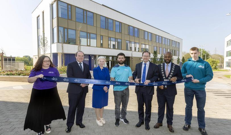A group of people holding a ribbon