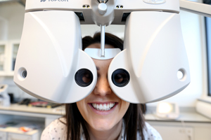 Image for researcher looking through eye testing equipment