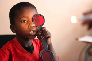 Image for researcher looking through eye testing equipment