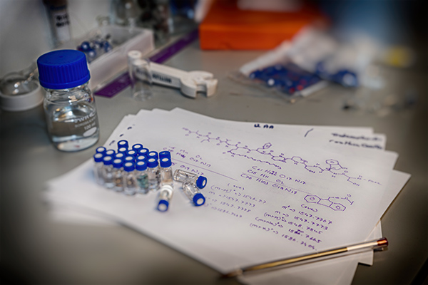 Molecule drawing and phials on a research bench at MDS